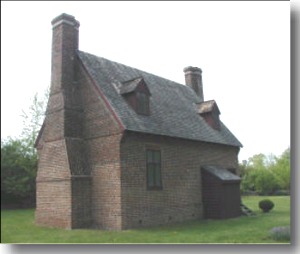 Photo of a typical four-on-four colonial house with 2 chimneys